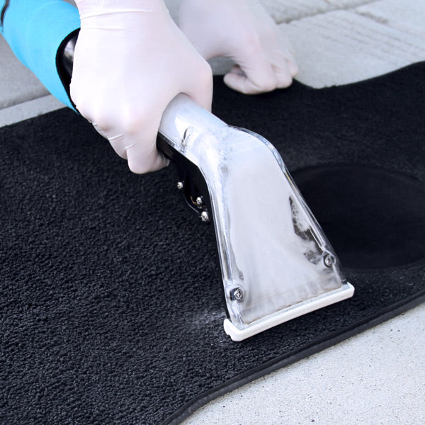Mytee S-300H Tempo Heated Spotter Extractor, gloved operator drawing the hand tool across carpet